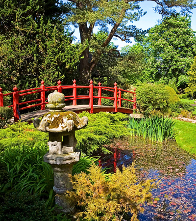 Red bridge over a pond in Japanese Gradens